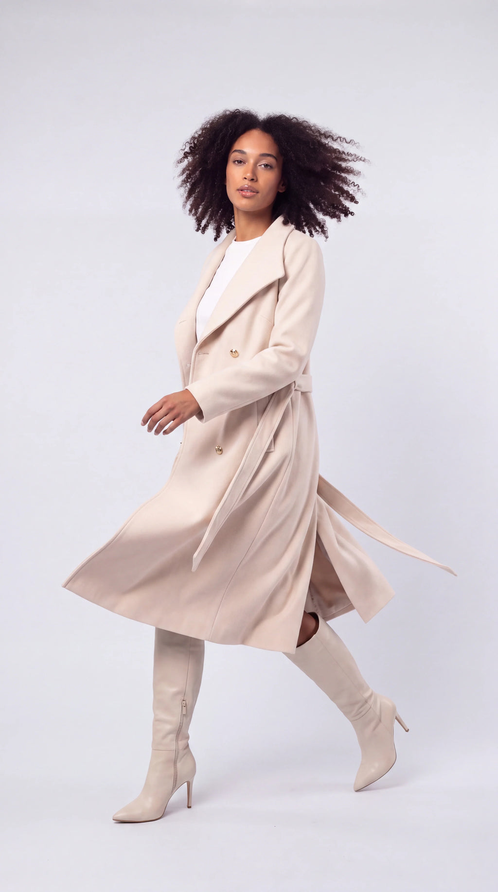 Evorenne cream belted double-breasted trench coat in motion