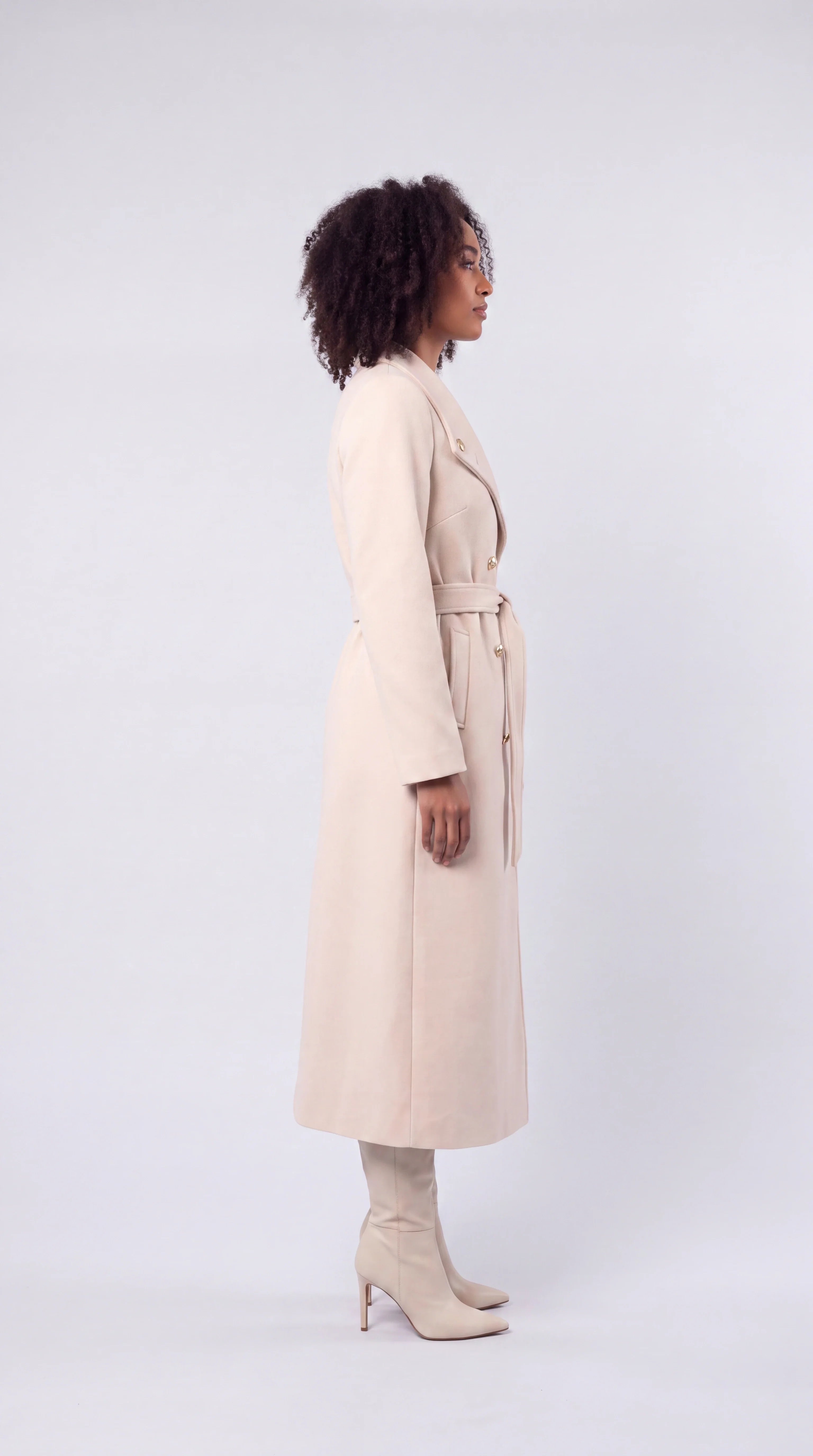 Evorenne cream belted double-breasted trench coat, side view